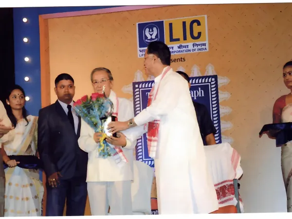 Photographs of prestigious awards received by Prof. Tabu Ram Taid, including Bhasha Samman and Sukapha Award.