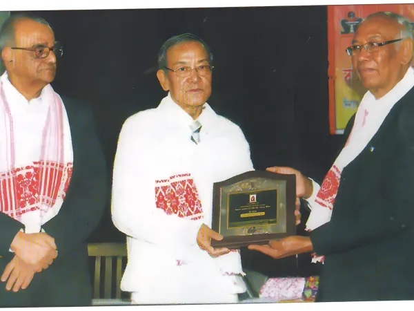 Photographs of prestigious awards received by Prof. Tabu Ram Taid, including Bhasha Samman and Sukapha Award.