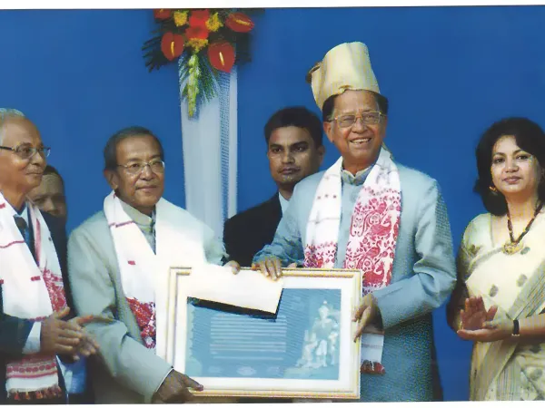 Photographs of prestigious awards received by Prof. Tabu Ram Taid, including Bhasha Samman and Sukapha Award.