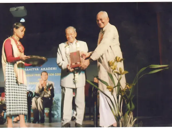 Photographs of prestigious awards received by Prof. Tabu Ram Taid, including Bhasha Samman and Sukapha Award.